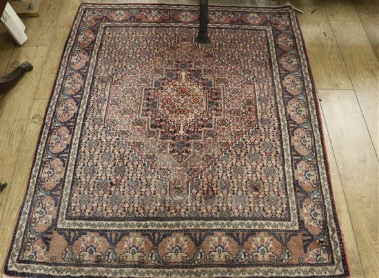 A Persian red ground rug 150 x 123cm